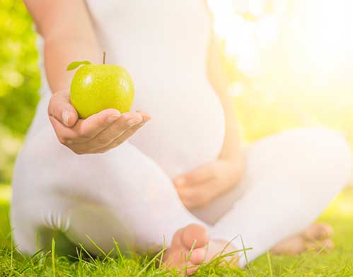 Pregnant Woman Holding Apple