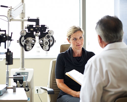 woman having an eye exam with doctor