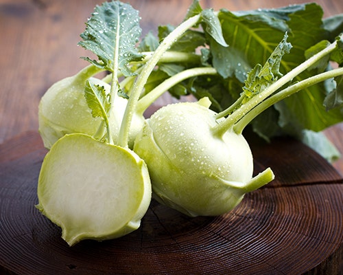 Fresh kohlrabi on the wooden table closeup