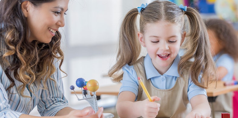 daughter and mother writing on a desk