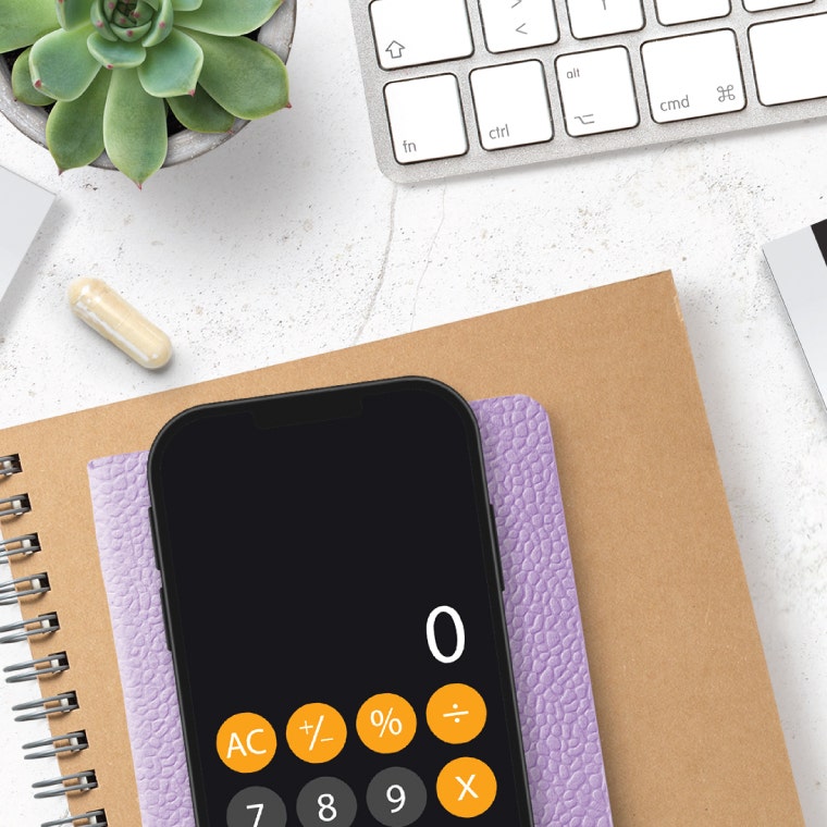 Capsule next to phone calculator, notebooks, and keyboard
