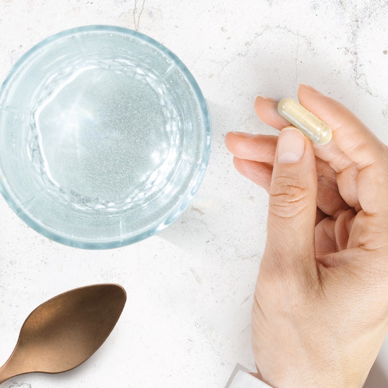 Hand holding a capsule