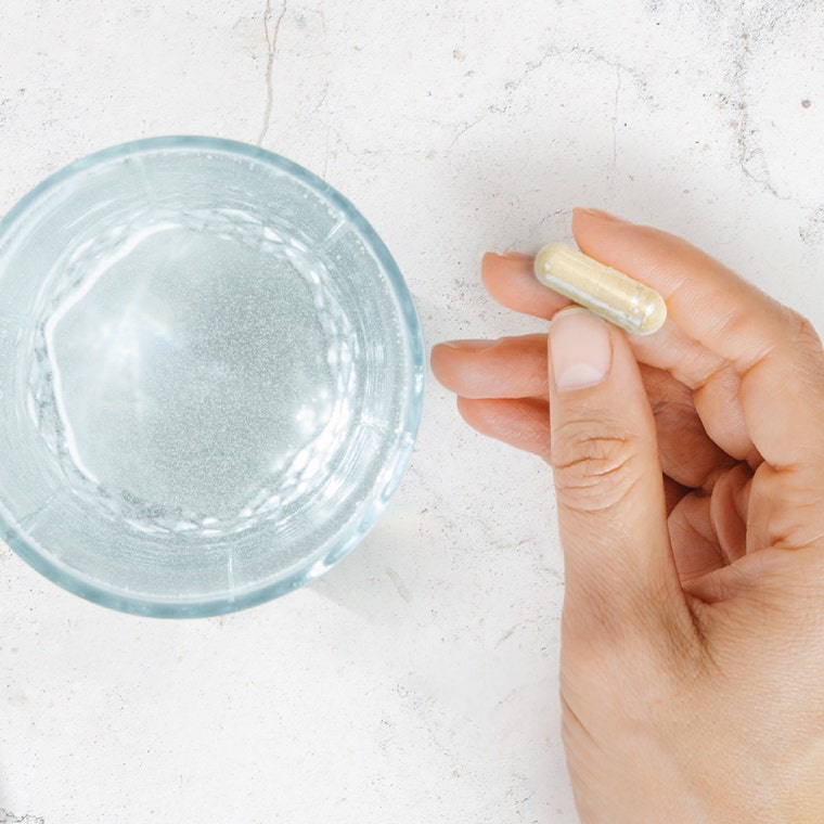 Hand holding a capsule
