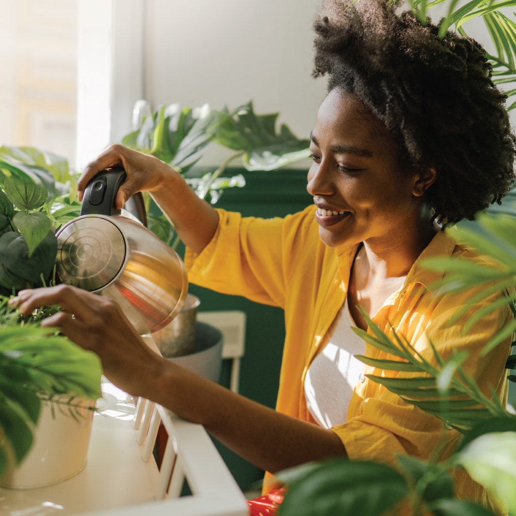 Woman watering house plants