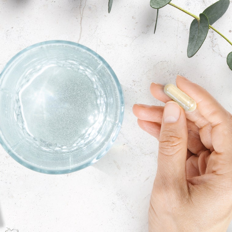 Hand holding a capsule