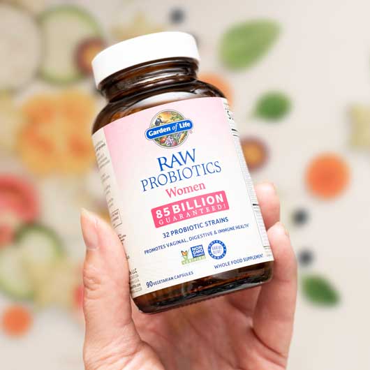 hand holding raw probiotic bottle