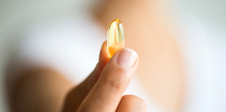 person holding omega-3 pill