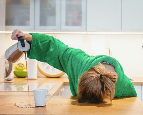 person sleeping on counter pouring coffee