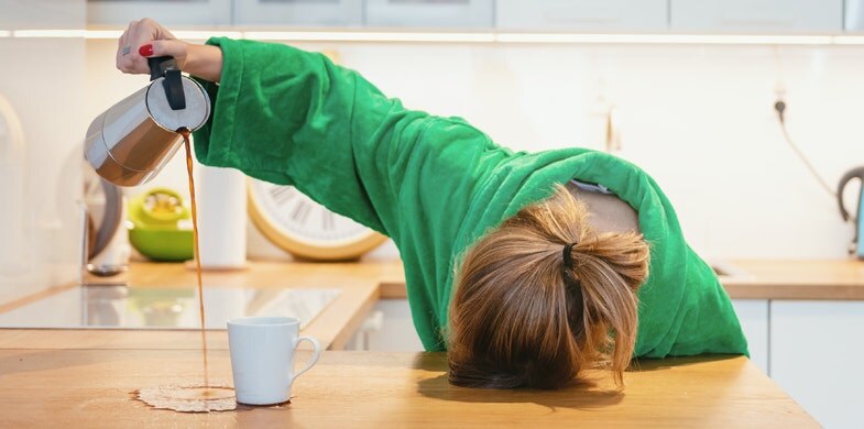 person sleeping on counter pouring coffee